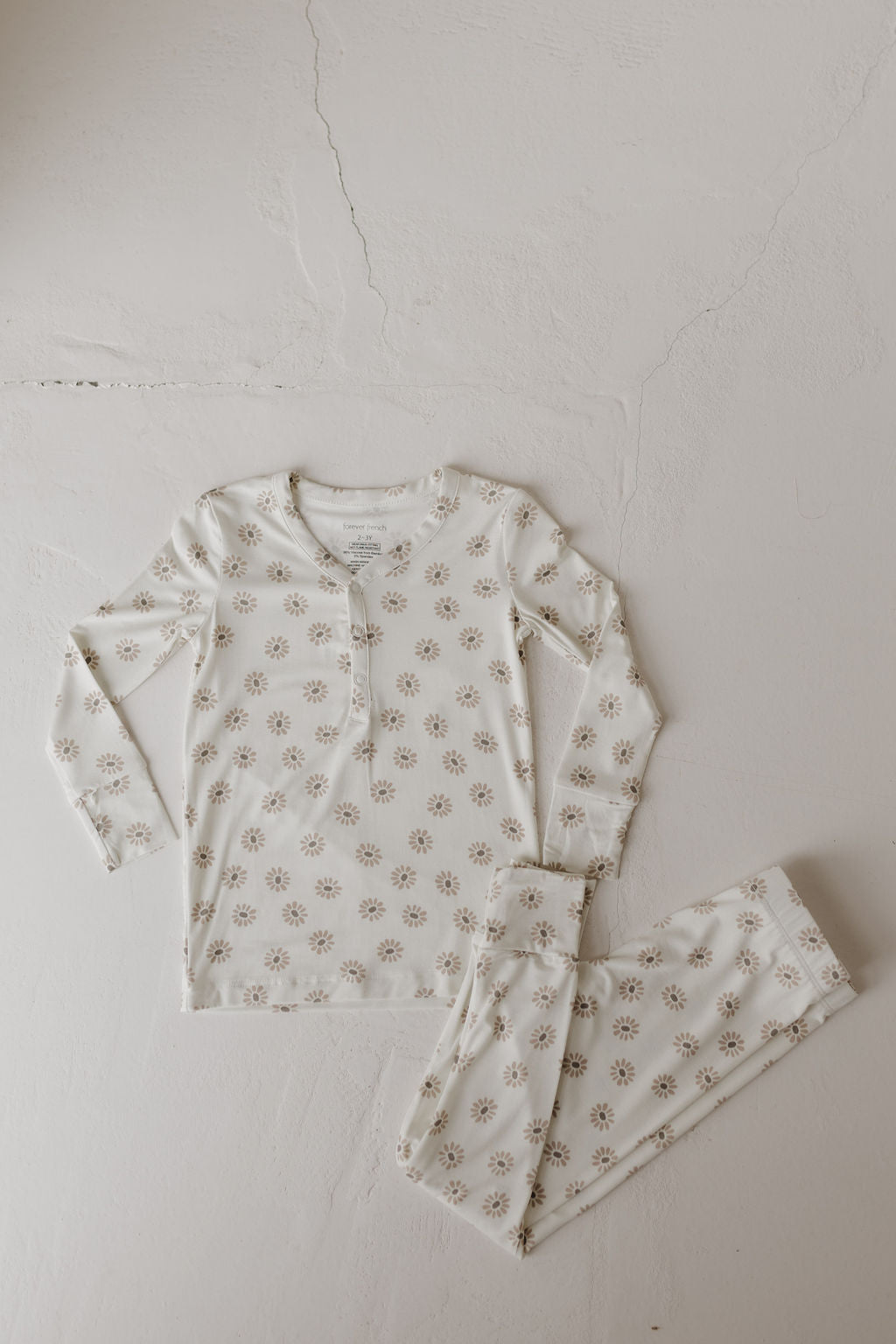 The Bamboo Two Piece Pajamas | Daisy Fields from forever french baby, featuring a cream floral design and crafted from breathable fabric, includes a long-sleeved top and matching pants, ideal for cozy comfort all night.
