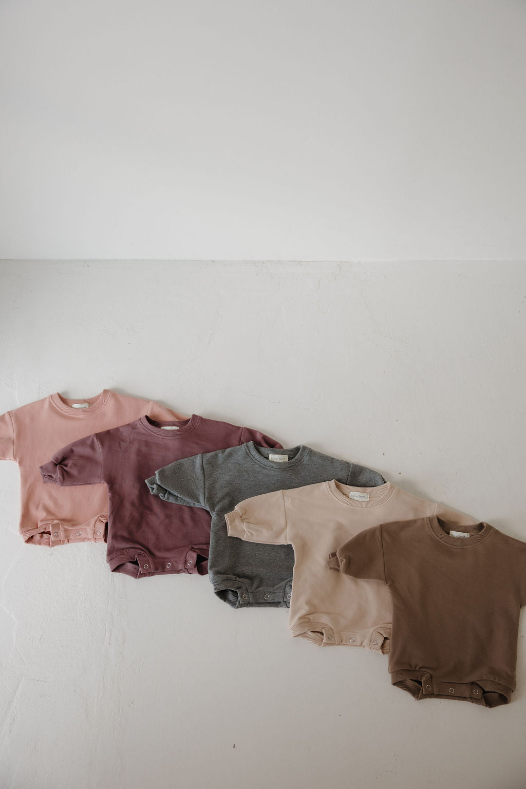 The Sweatshirt Romper | Hot Cocoa by forever french baby is a cozy, stylish choice for your newborn’s wardrobe—perfect for adding comfort and charm to their clothes collection.