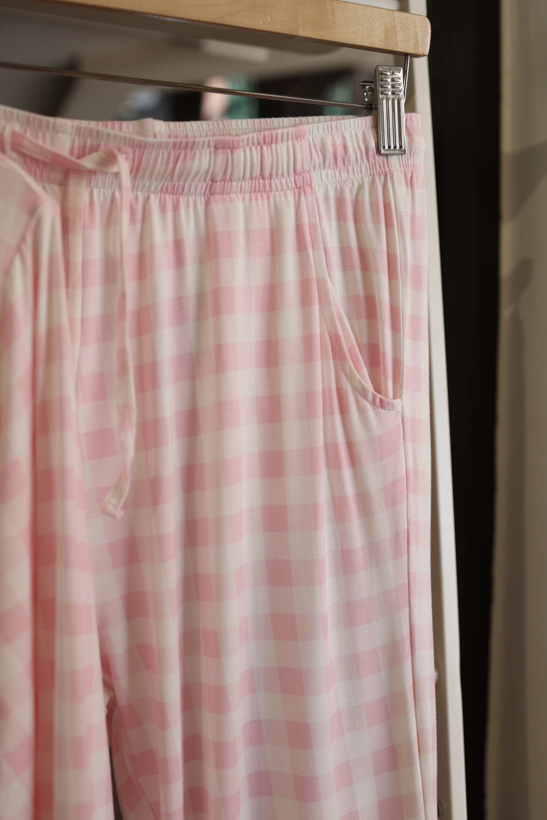 The Long Sleeve Women's Bamboo Pajama in Pink Sugar by forever french baby features a comfy pink and white checkered design, drawstring waistband, and side pocket—the perfect addition to your lounge set.