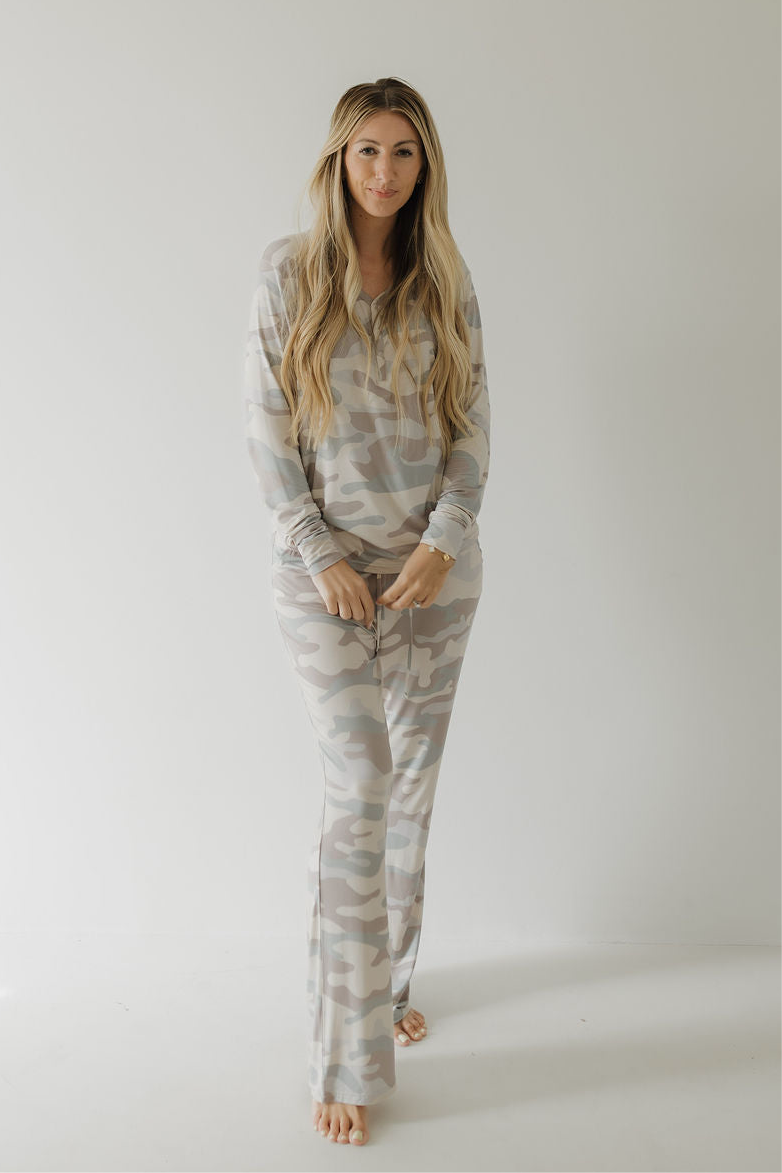 A woman with long, wavy blonde hair stands barefoot against a plain white background, wearing forever french baby Women's Bamboo Pajama | Camo—ideal for breastfeeding moms seeking comfort and style.