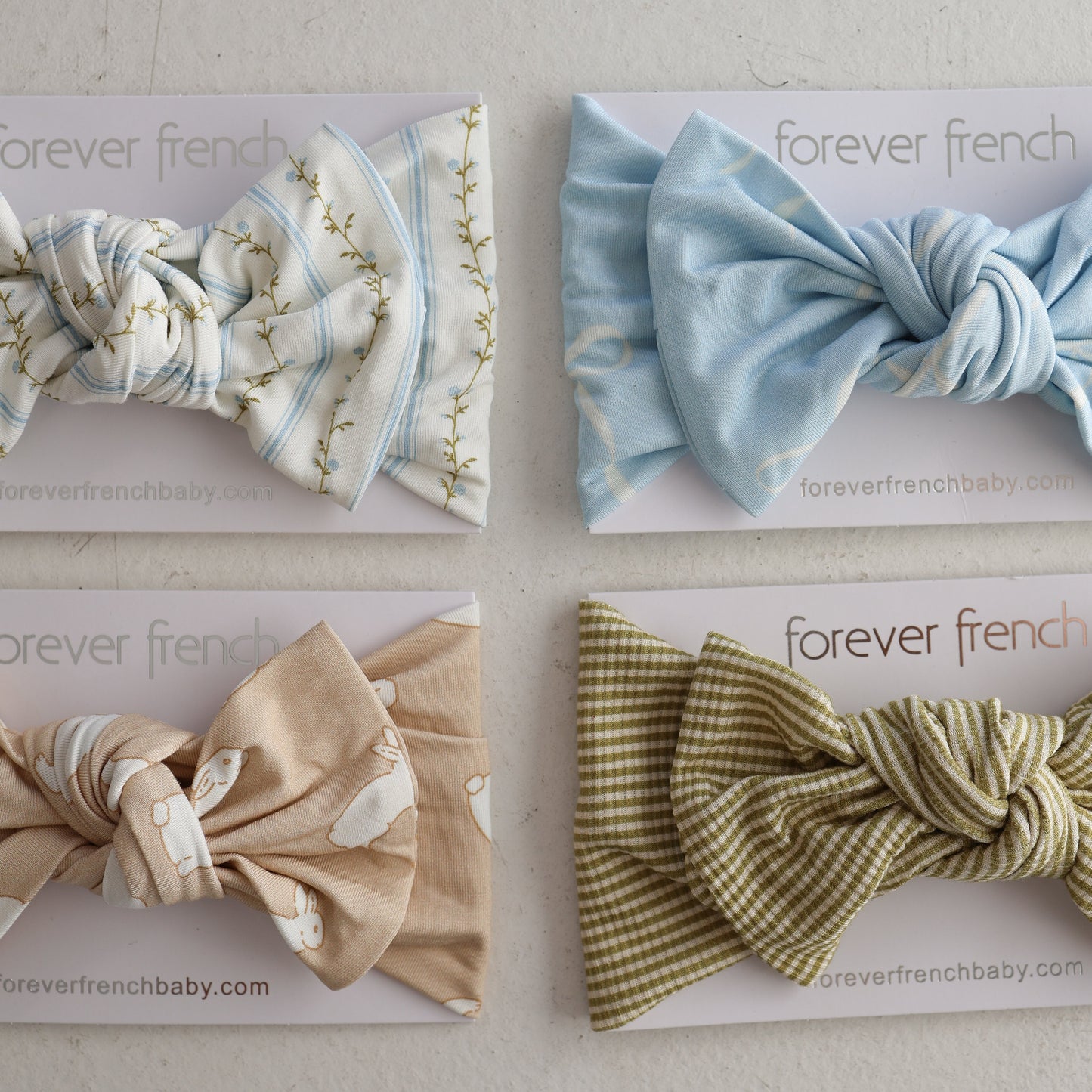 The Forever French Baby Bamboo Head Wrap | Bunnies comes with a soft bamboo head wrap and sweet baby bow headband, beautifully displayed on elegant cards—perfect for your little one.