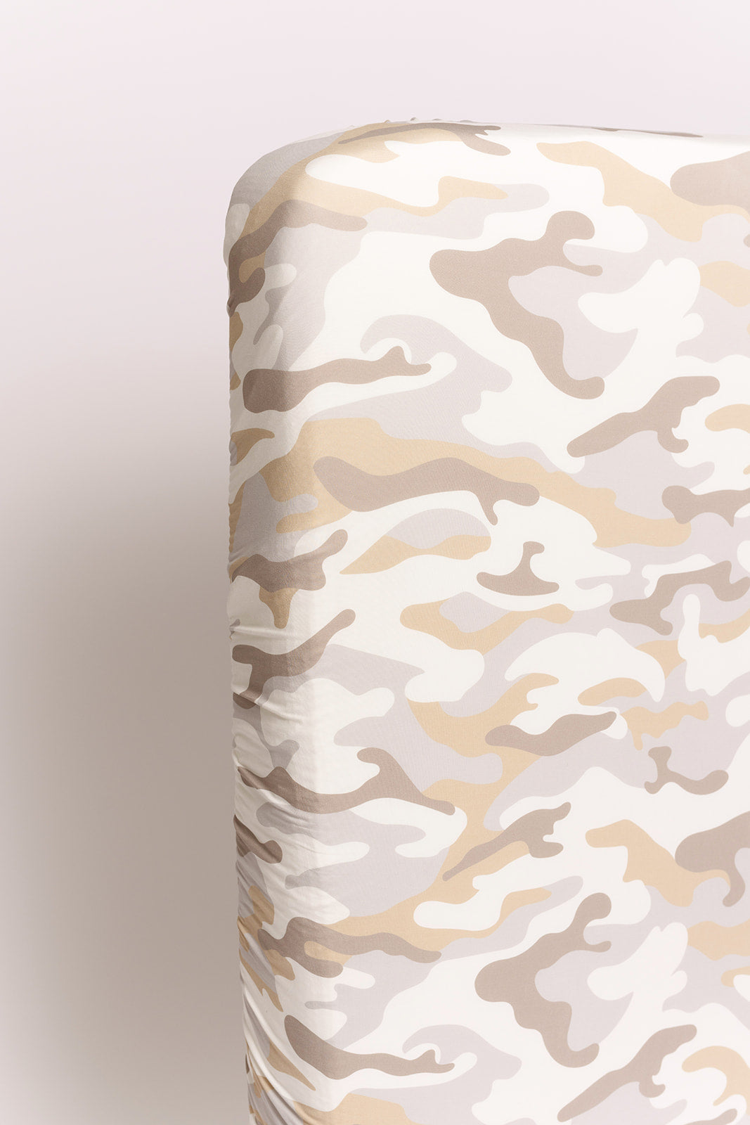 The forever french baby Bamboo Crib Sheet | Camo 2.0 features a beige, tan, and white camouflage pattern—perfect for stylish nursery bedding and shown here on a crib mattress against a light background.