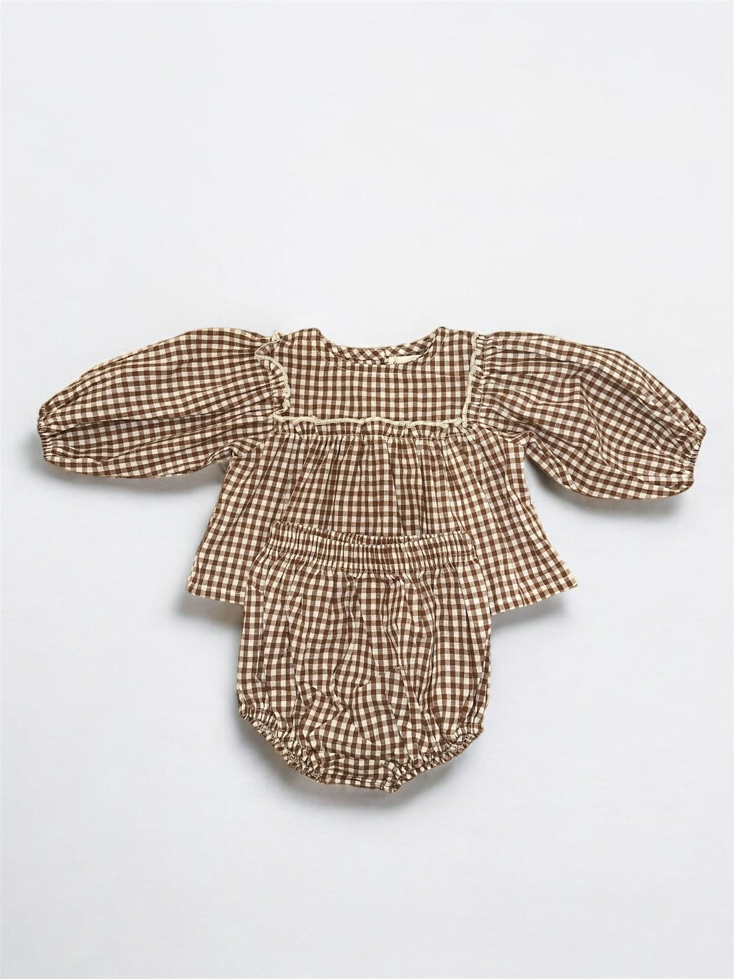 The Bloomer Set | Honey Gingham by forever french baby is a brown and white gingham newborn set with a long puffed sleeve top and matching bloomers, displayed flat on a white background.