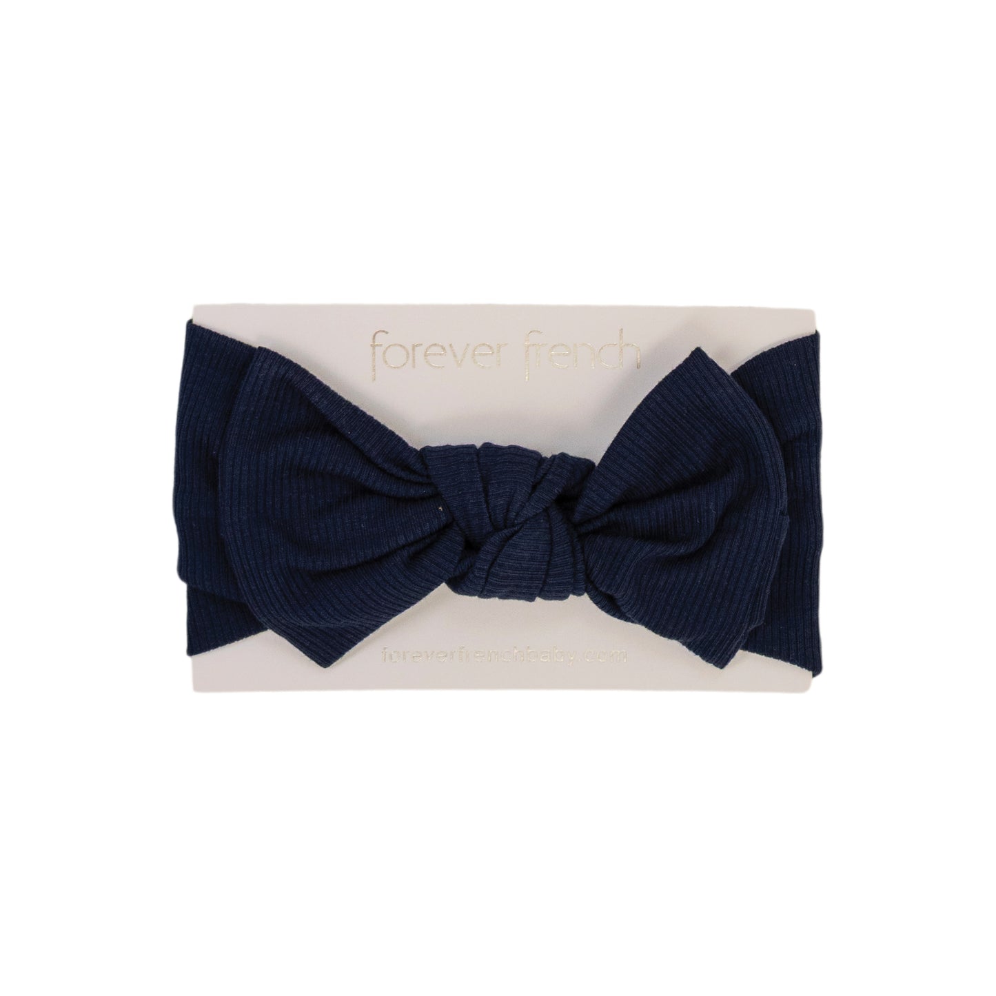 The Bamboo Head Wrap | Blueberry Ribbed from forever french baby is a navy ribbed bow headband, shown on a white card with gold "forever french" text.