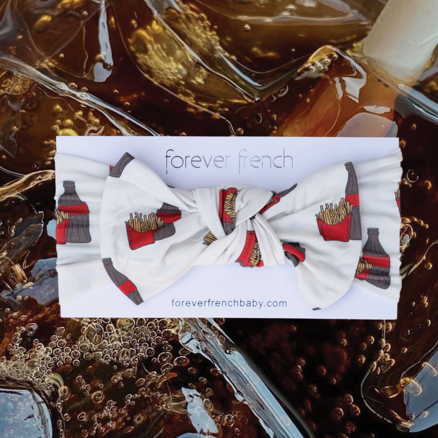 The Bamboo Head Wrap | Fries & Cola by forever french baby, featuring soda bottles and fries, is displayed on its branded card against an iced cola background.