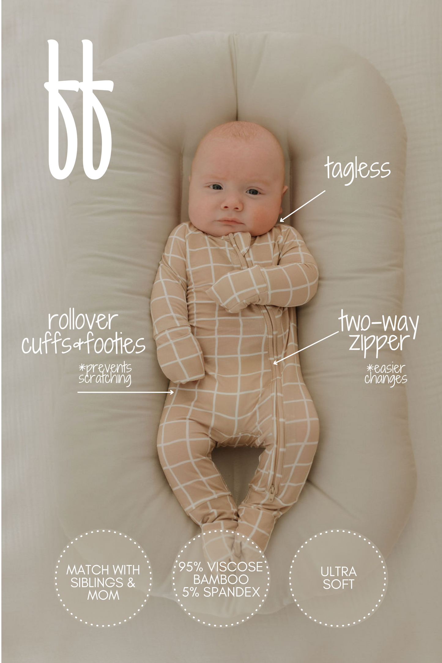 In a beige pod, a baby wears forever french baby's Bamboo Zip Pajamas | Grid, featuring rollover cuffs and footies. These checkered bamboo pajamas are tagless with a two-way zipper, hypo-allergenic, crafted from ultra-soft viscose bamboo for breathable sleepwear.