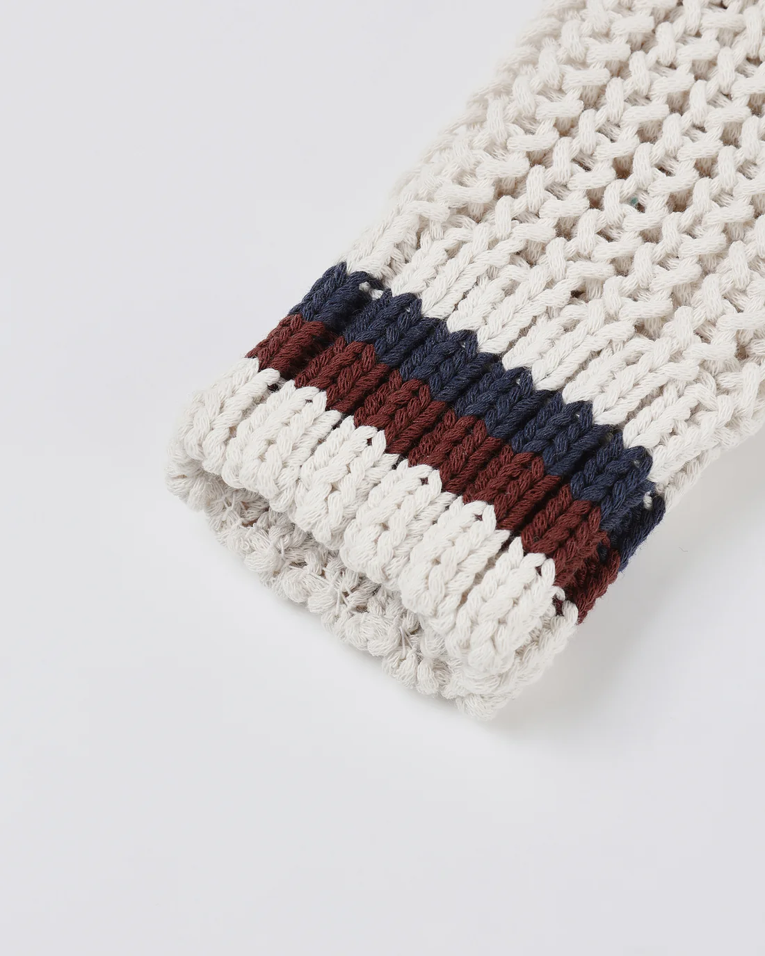 Close-up of the Rylee + Cru Collegiate Cardigan | Natural, showcasing its knitted cream-colored V-neck design with ribbed cuffs accented by maroon and navy blue stripes, perfect for achieving a classic collegiate look against a white background.
