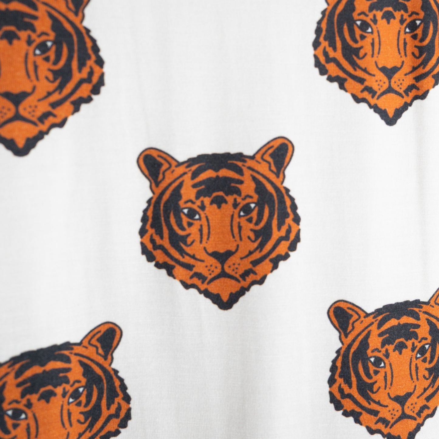 The "Bamboo Short Set | Tigers" by forever french baby features a pattern of orange and black tiger faces on white, ideal for breathable sleepwear or hypoallergenic kids' clothing.