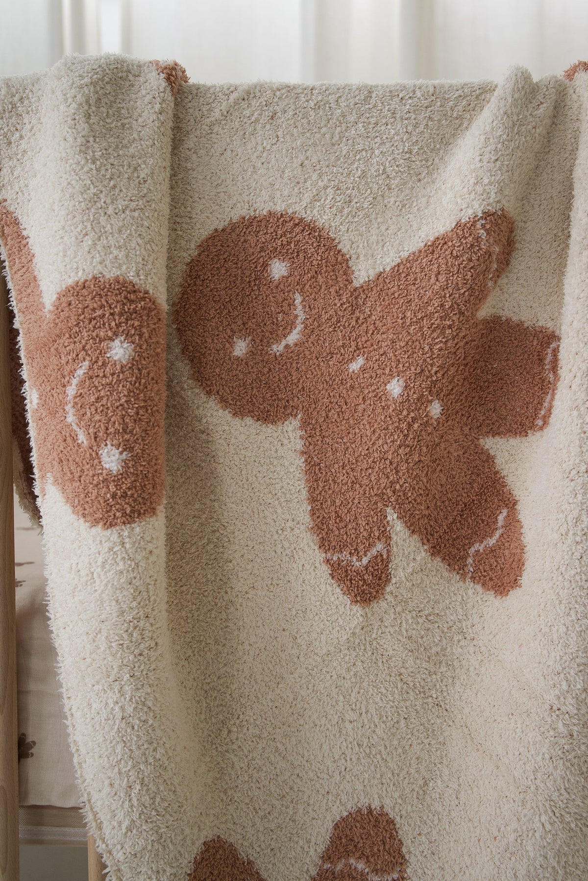 Forever French Baby Plush Blanket | Gingersnap in cream-colored microfiber with a repeating pattern of brown gingerbread men.