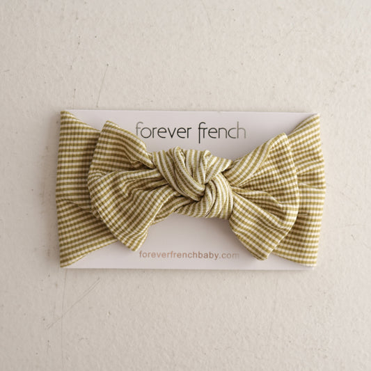 A Bamboo Head Wrap in Willow Stripe Ribbed by forever french baby is shown on a white card with “forever french” and “foreverfrenchbaby.com” printed below, against a light, textured background.