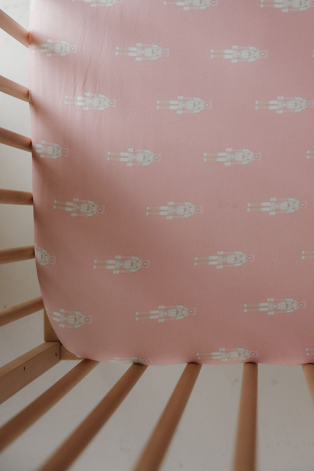 The forever french baby Bamboo Crib Sheet | Nutcracker features a charming pink print with white nutcrackers—an adorable and unique addition to your nursery bedding.