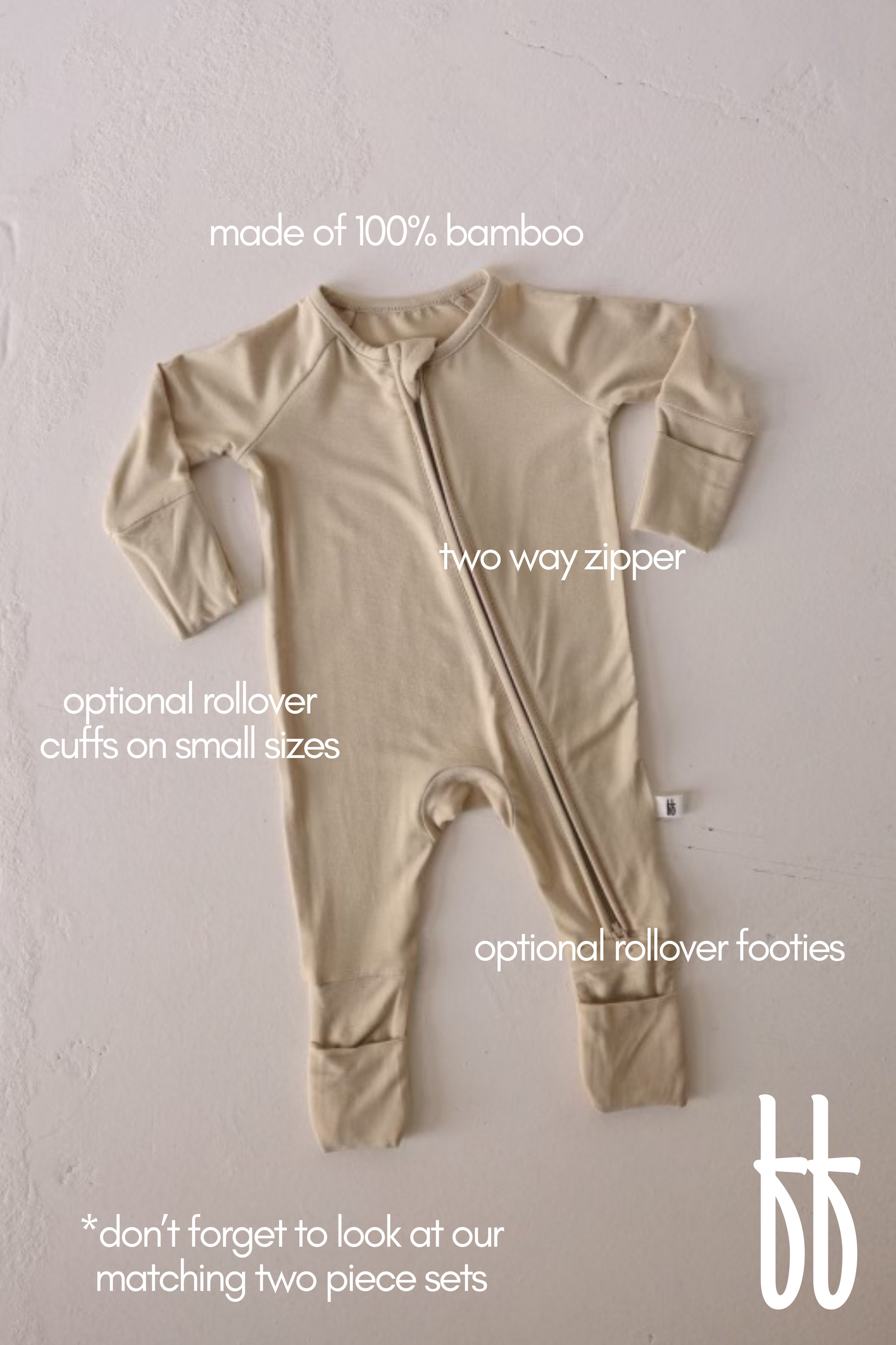 A Limestone-colored bamboo onesie from forever french baby is displayed. It boasts a two-way zipper, optional rollover cuffs for smaller sizes, and optional rollover footies. The image highlights matching bamboo pajamas and hypo-allergenic clothing, with a small brand logo in the bottom right corner.