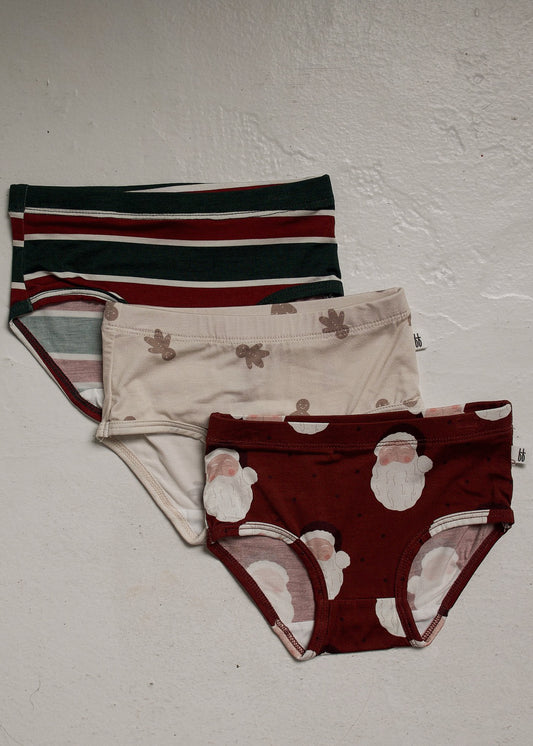 Girl’s Bamboo Briefs (3 Pack) | Holiday ’26 featuring three pairs of hypo-allergenic briefs with holiday prints: one with horizontal stripes, one with gingerbread men, and one with a Santa Claus pattern.