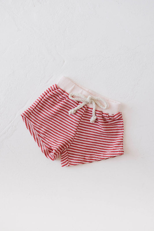 Children's Waffle Knit Shorts by forever french baby, featuring a Candy Apple Red Stripe design and a drawstring waistband, laid flat on a white surface.