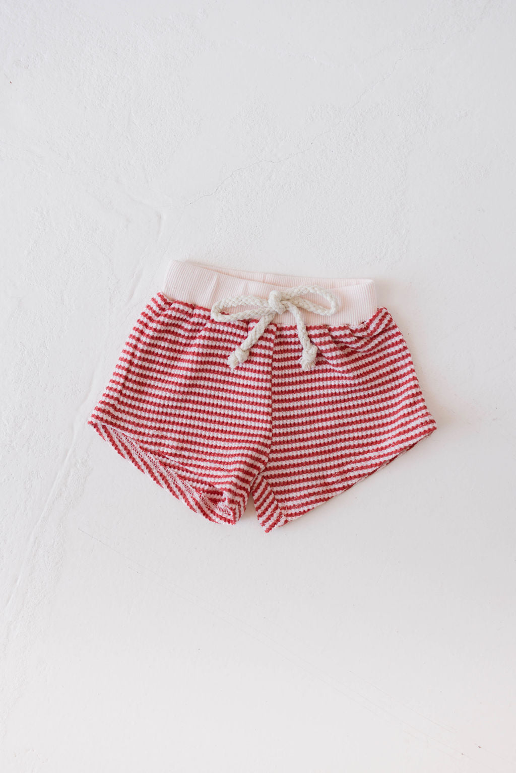 Children's Waffle Knit Shorts by forever french baby in Candy Apple Red Stripe, featuring a white drawstring, displayed on a white background.