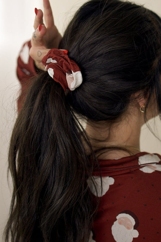A person with dark hair in a ponytail secured by a forever french baby Scrunchie | Vintage Santa.