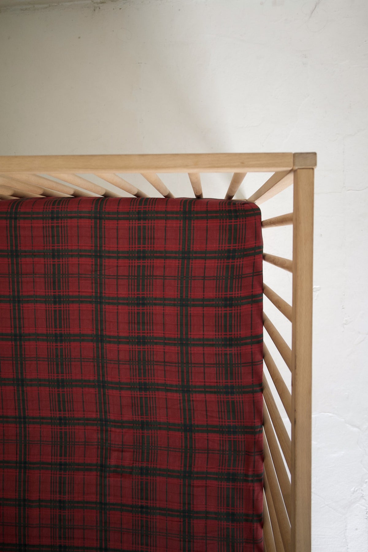Muslin Crib Sheet | Christmas Plaid fitted onto a wooden crib.