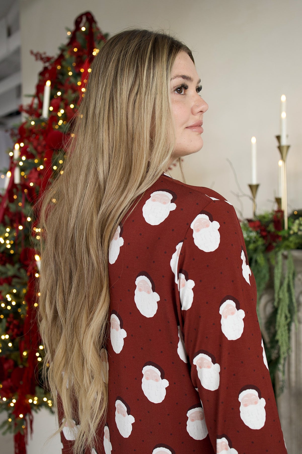 A woman wearing a maroon Women’s Bamboo Sleeping Dress | Vintage Santa with a repeating vintage Santa Claus print.