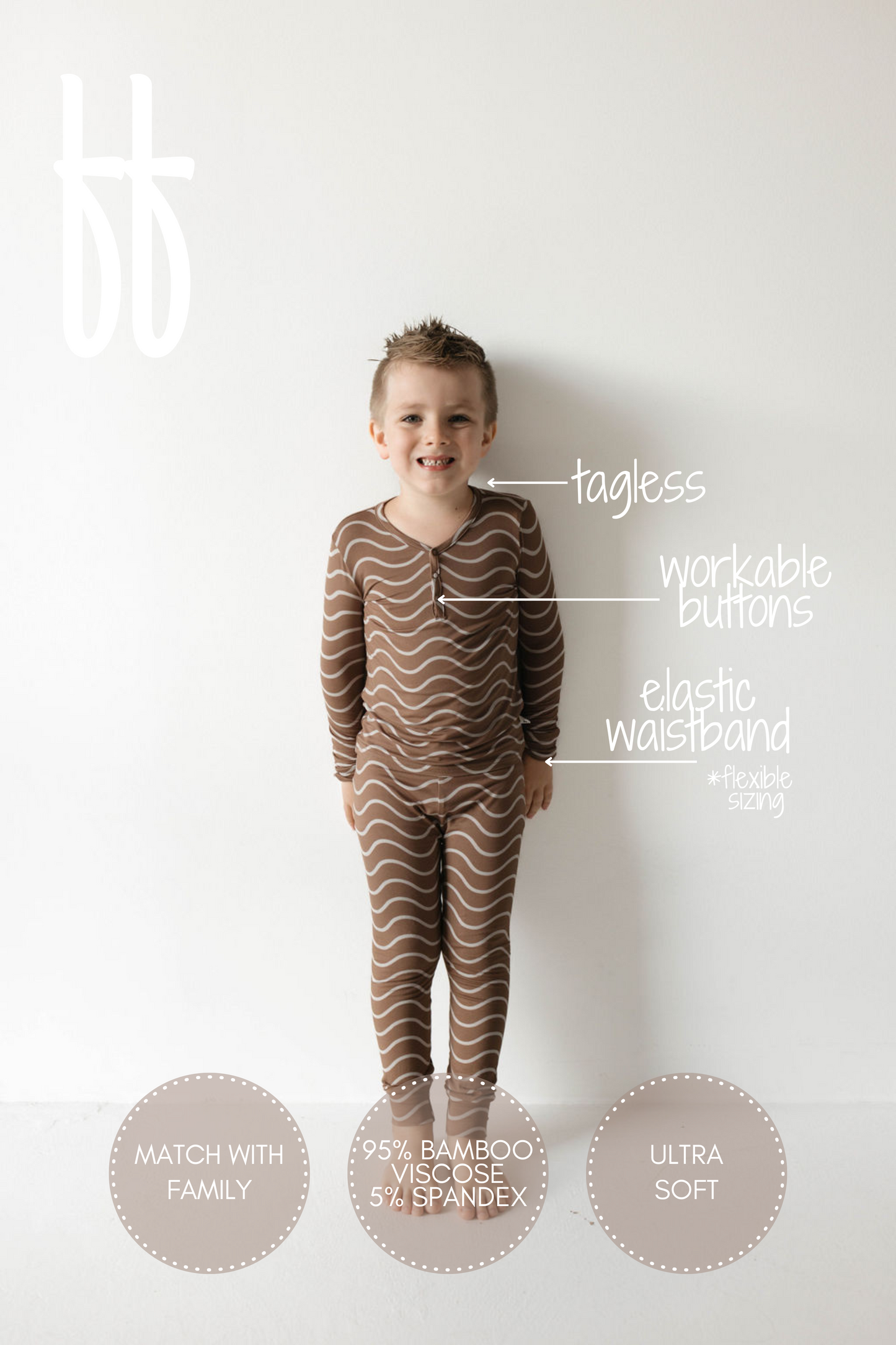 A joyful child stands against a plain white background, wearing the Bamboo Two Piece Pajamas in Static Waves from forever french baby. Notable features labeled include "tagless," "workable buttons," "elastic waistband," and "95% bamboo viscose, 5% spandex." Text circles mention "match with family" and "ultra soft, breathable fabric.