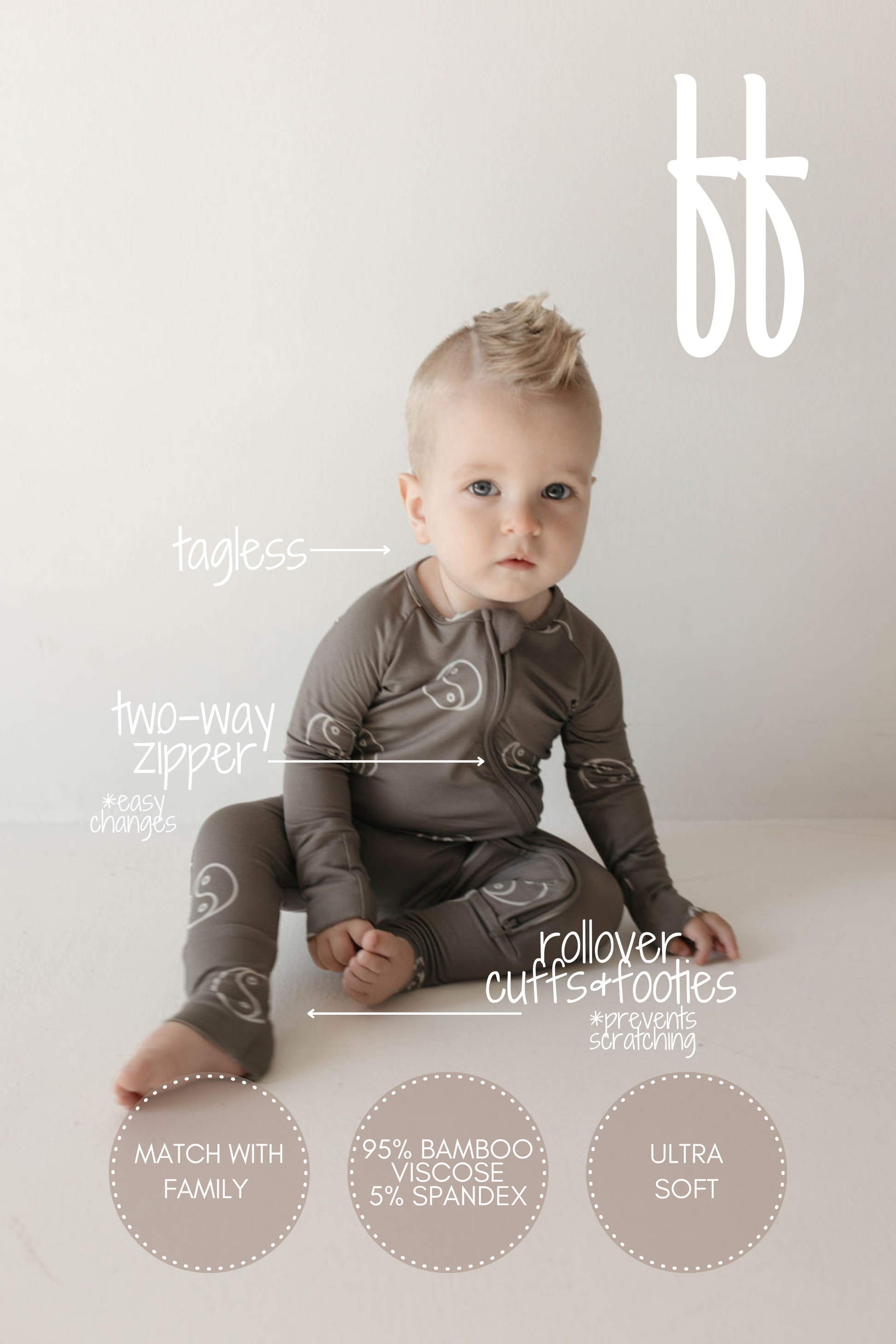 A baby with light hair sits on the floor wearing the Bamboo Zip Pajamas in Sage Yin Yang from forever french baby. Text around the baby highlights features of these hypo-allergenic clothes: tagless, two-way zipper, rollover cuffs and footies, matching family sets, made from 95% bamboo viscose and 5% spandex, and ultra-soft material.