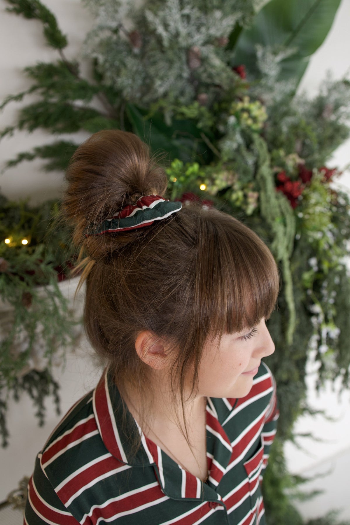A person wearing a Scrunchie | Holiday Stripe in a high bun.