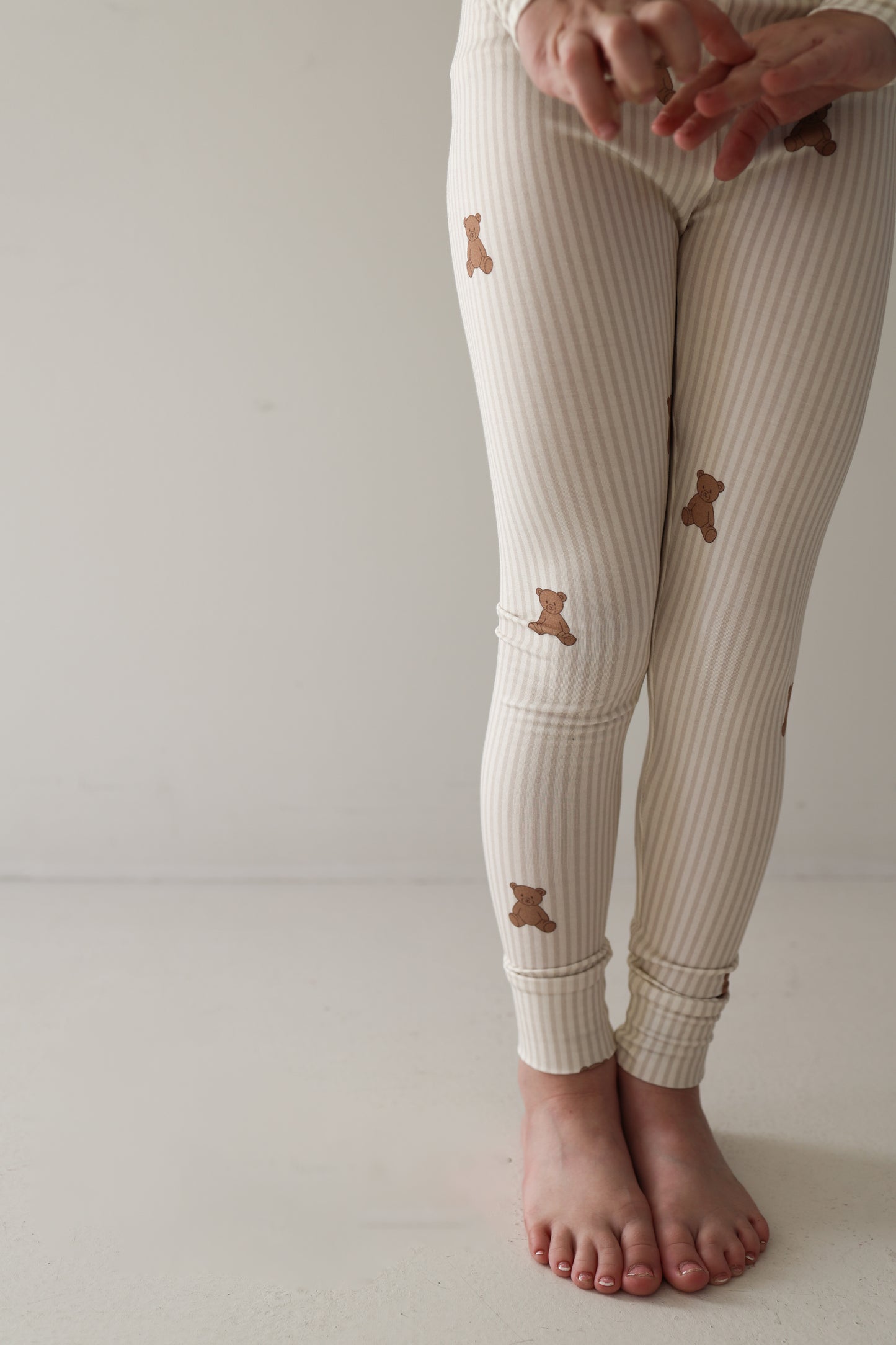 A person wearing forever french baby Bamboo Two Piece Pajamas in the Teddy design.