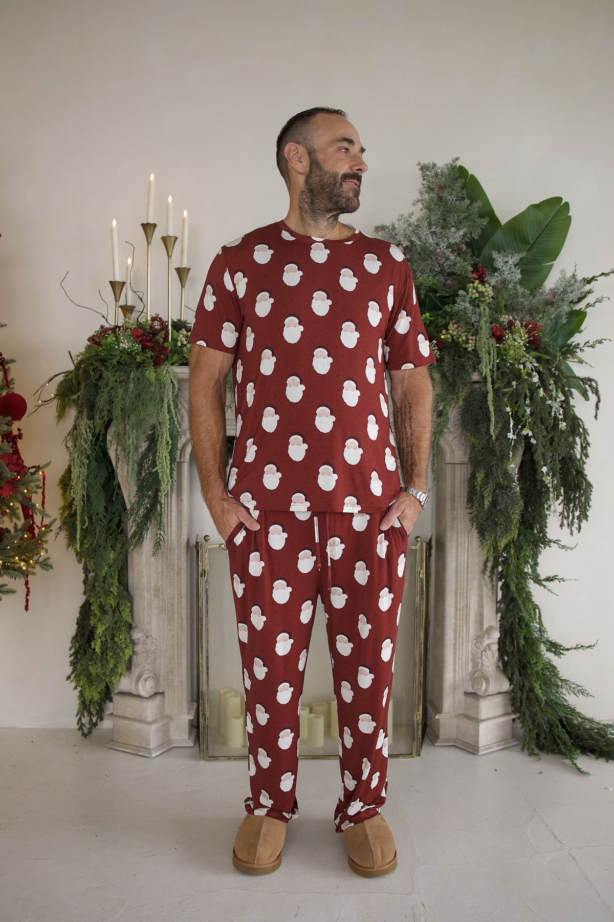 Man wearing a red Men’s Short Sleeve Pajamas | Vintage Santa set with a white Santa Claus pattern.