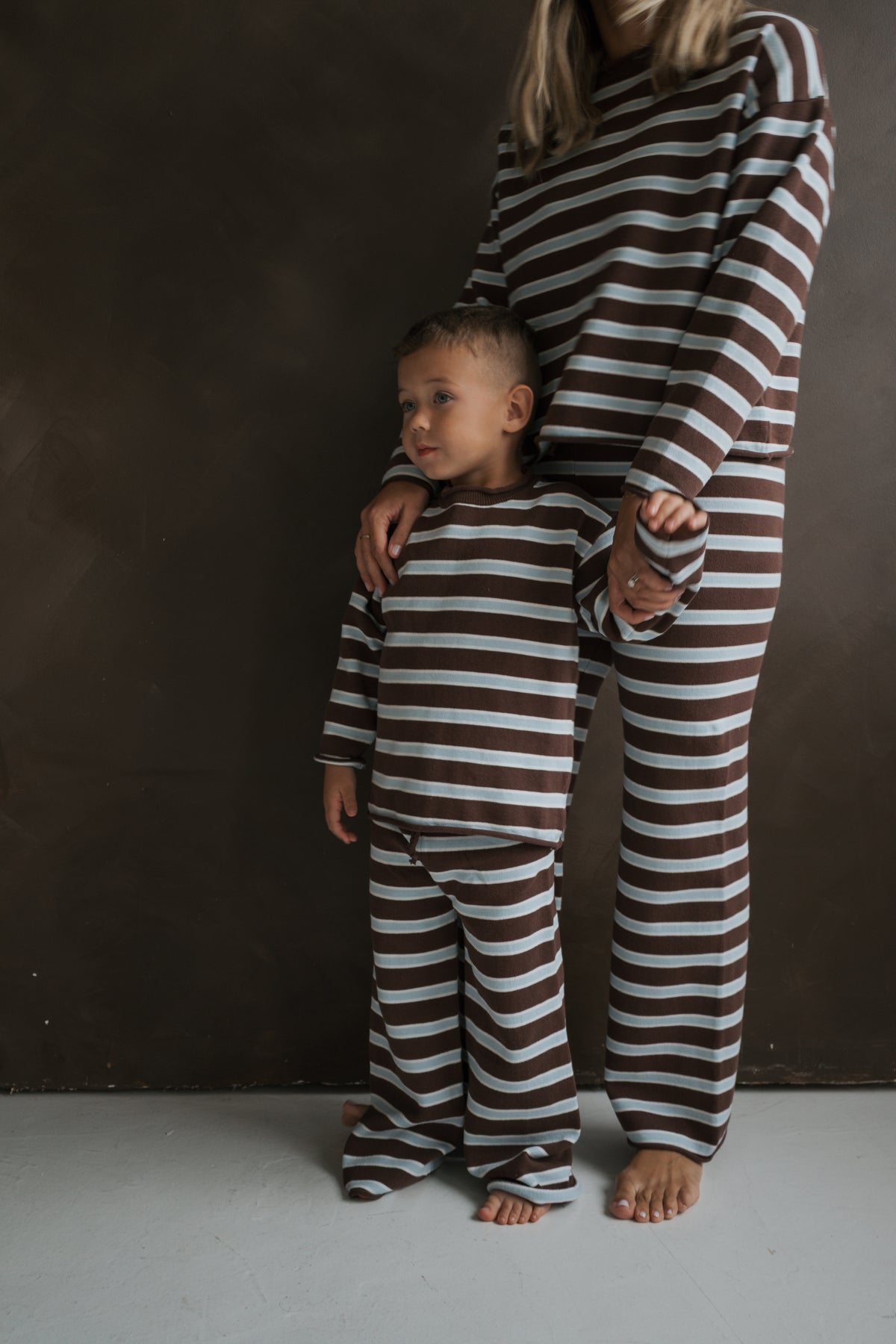 A child and adult wearing matching brown and light blue striped 100% cotton Knit Pant Set | Garrett by forever french baby.