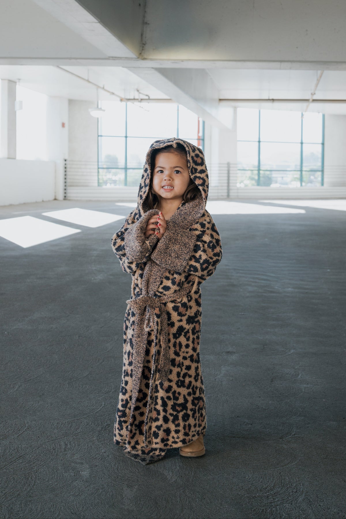 A child wearing a Children’s Robe | Leopard hooded leopard-print microfiber feather yarn robe.