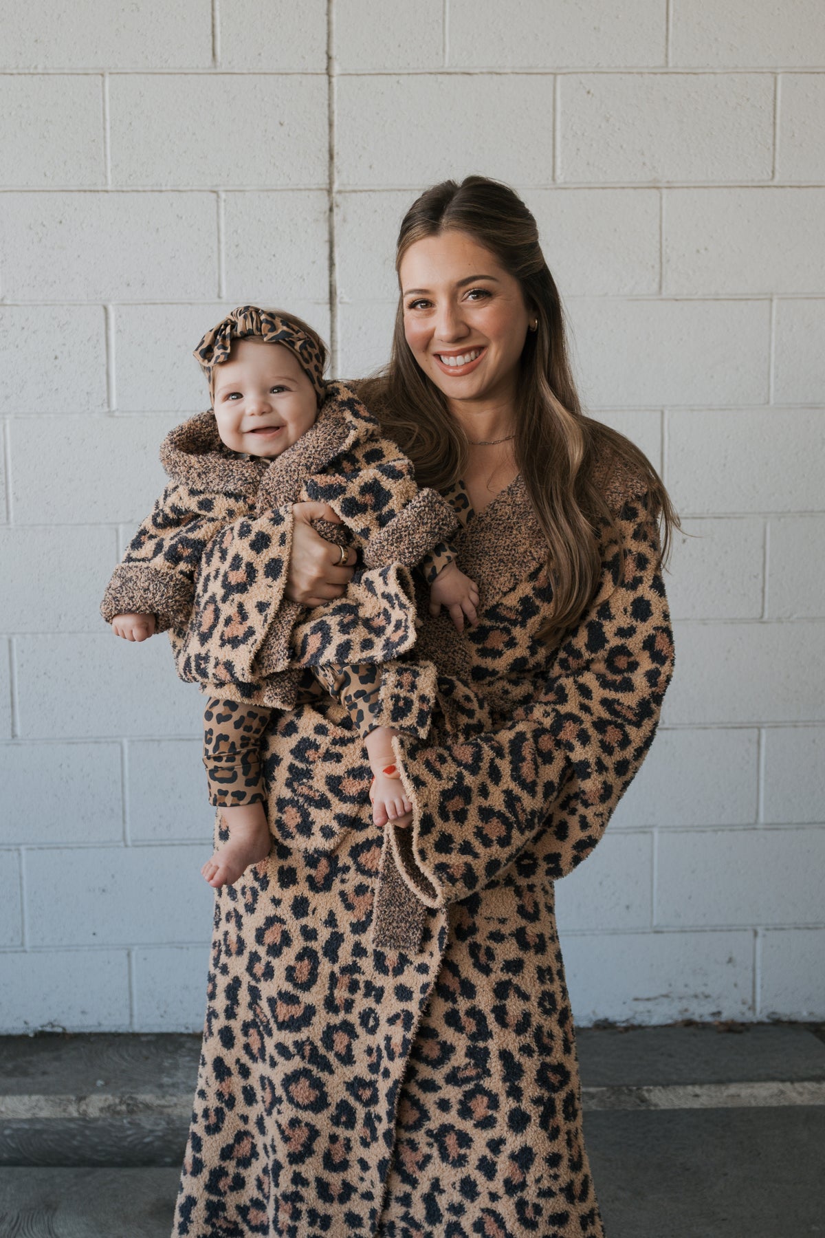 A woman and baby wearing matching Children’s Robe | Leopard leopard-print hooded robes and headbands by forever french baby.