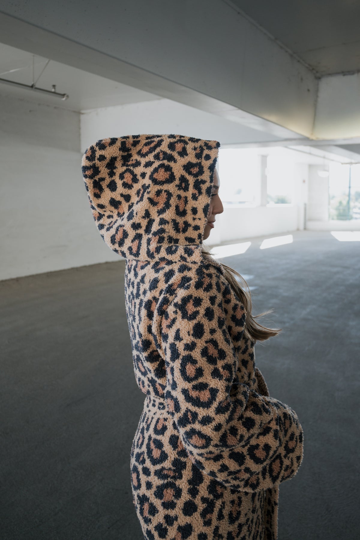A person wearing a hooded Adult Robe | Leopard in a leopard-print pattern.