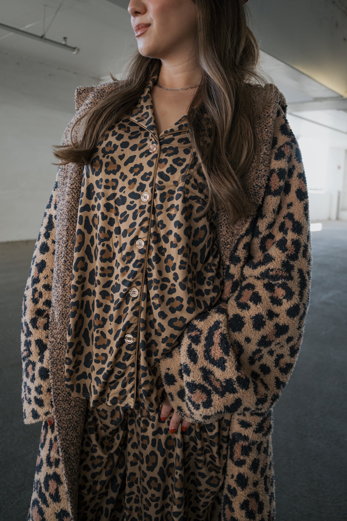 A person wearing a leopard-print button-down pajama set under a matching leopard-print Adult Robe | Leopard by forever french baby.