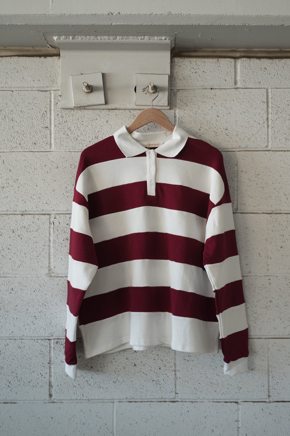 Forever French Baby Adult Rugby Sweatshirt | Deep Cranberry, an oversized style featuring horizontal deep cranberry and white stripes, a white collar, and a three-button placket.
