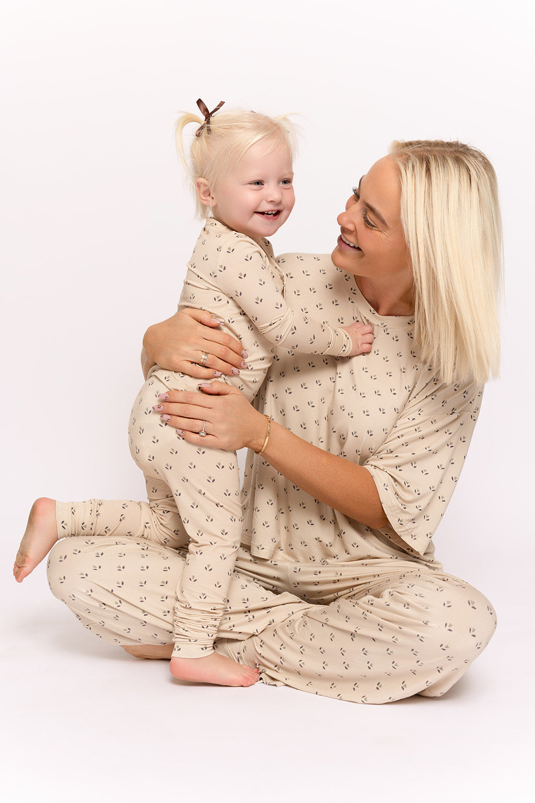 A woman in the Women's Boxy Tee Lounge Set | Flora by forever french baby holds her baby, both enjoying the soft, hypo-allergenic comfort of bamboo clothing.