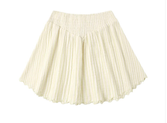 The Smocked V Mini Skirt | Citron Stripe by Rylee + Cru is crafted from 100% cotton in a subtle citron stripe pattern and features pleated detailing, a wide elastic waistband, and a slightly flared hem. Displayed on a white background, this cream-colored skirt combines smocked accents with an easy, comfortable fit.