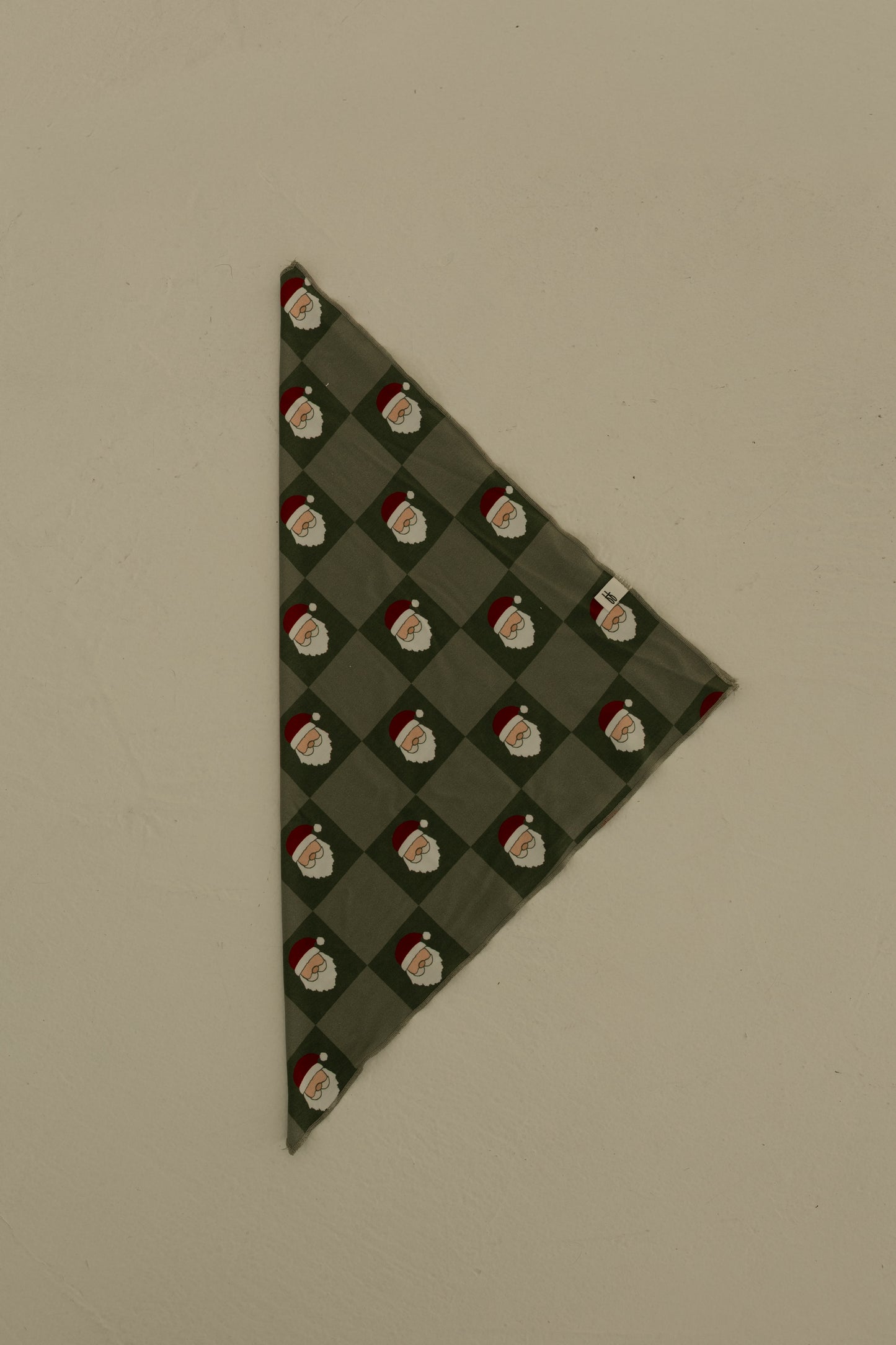 The forever french baby Bamboo Bandana | Santa Checkerboard is a soft, green bamboo viscose bandana with a diamond Santa Claus pattern, shown flat on a neutral background.