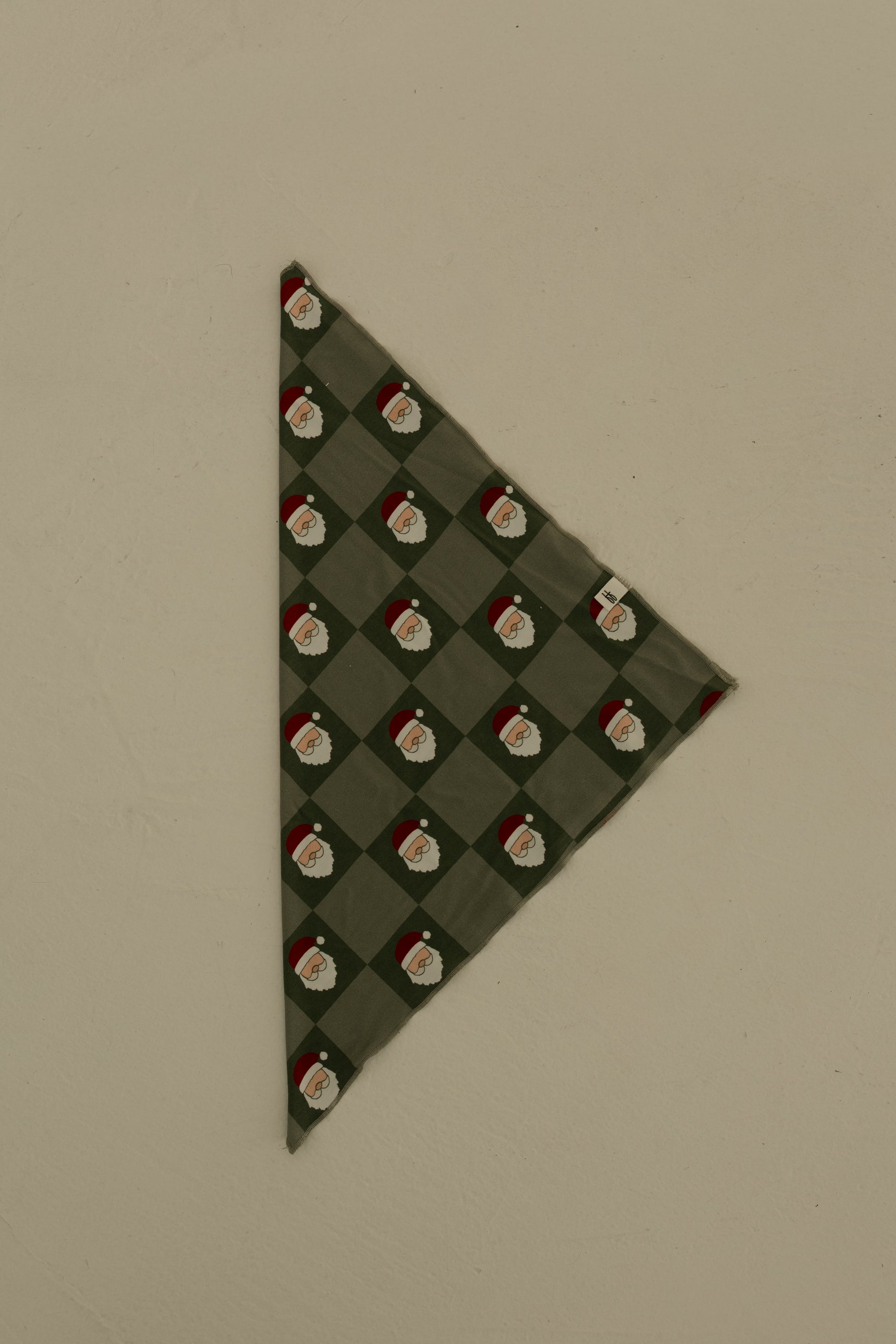 The forever french baby Bamboo Bandana | Santa Checkerboard is a soft, green bamboo viscose bandana with a diamond Santa Claus pattern, shown flat on a neutral background.