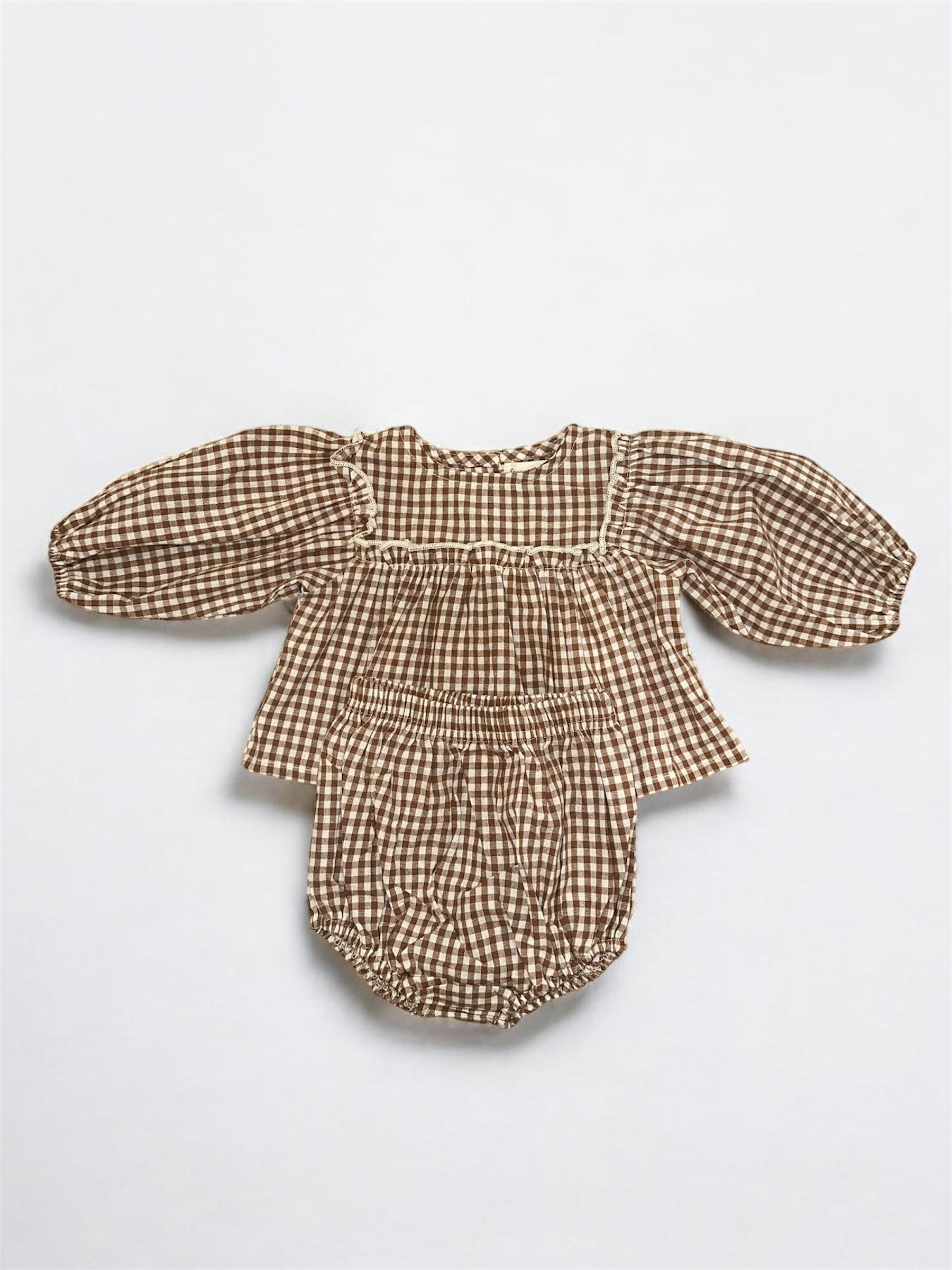 The Bloomer Set | Honey Gingham by forever french baby is a brown and white gingham newborn set with a long puffed sleeve top and matching bloomers, displayed flat on a white background.