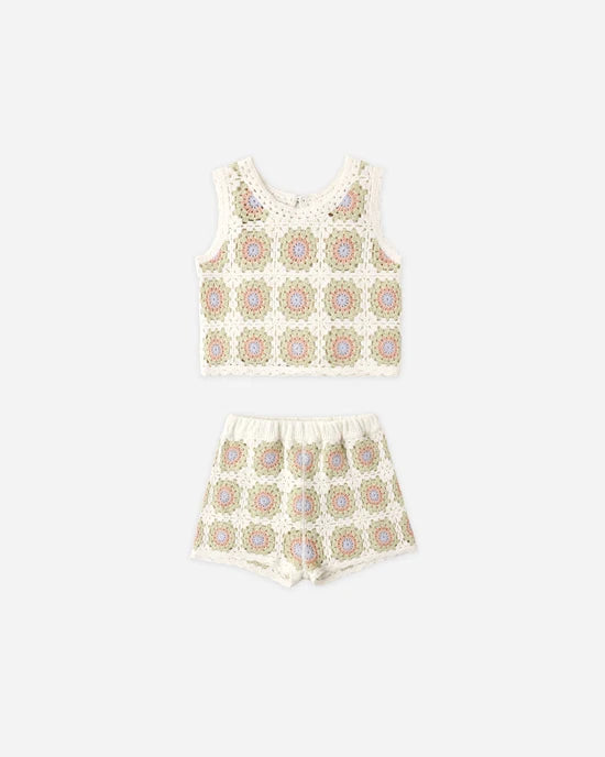 The Rylee + Cru Crochet Tank Set in Citron Daisy Check features a sleeveless top with delicate ruffled trim and matching shorts, both showcasing a lively geometric pattern on a white background. This vibrant two-piece set is presented on a plain white surface.