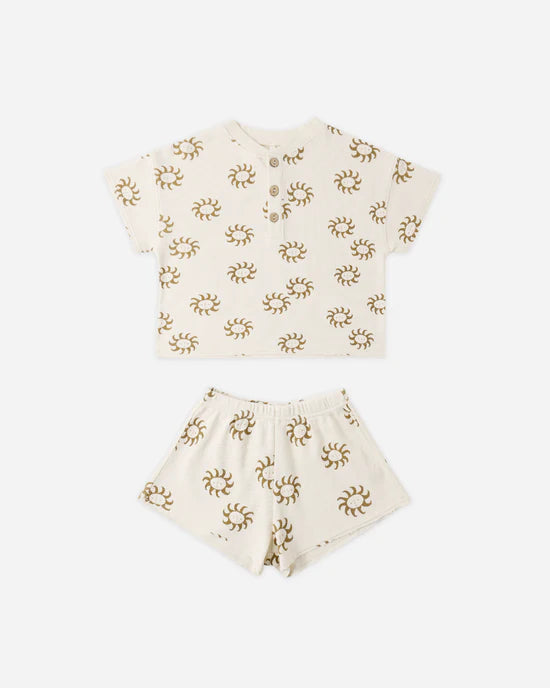 The Rylee + Cru Summer Waffle Set | Sunny features a cream-colored short-sleeve shirt and matching waffle fabric shorts, adorned with a repeating brown sunny print. Crafted from 100% cotton for ultimate comfort, this set is displayed on a white background.