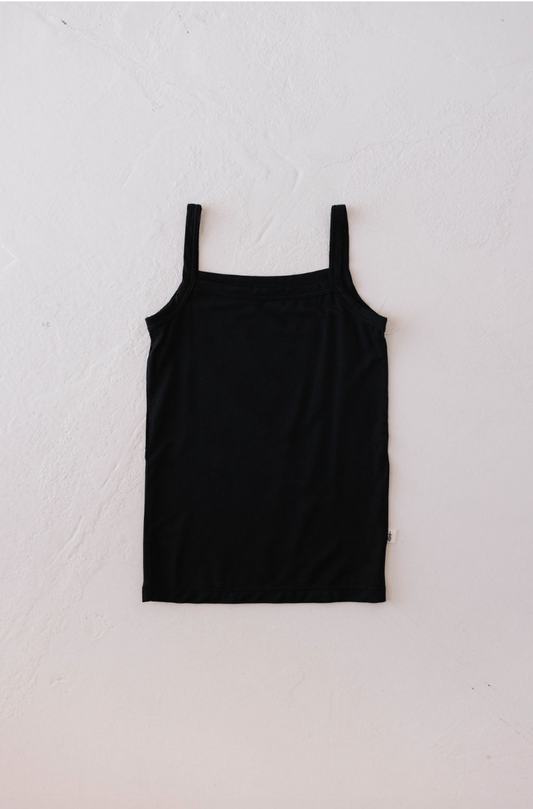 A Basic Bamboo Tank in Midnight from forever french baby is laid flat on a plain, light-colored background. Made from soft bamboo fabric, the top's rectangular shape is clearly visible. The design is simple and minimalistic, promising a comfortable feel against the skin.