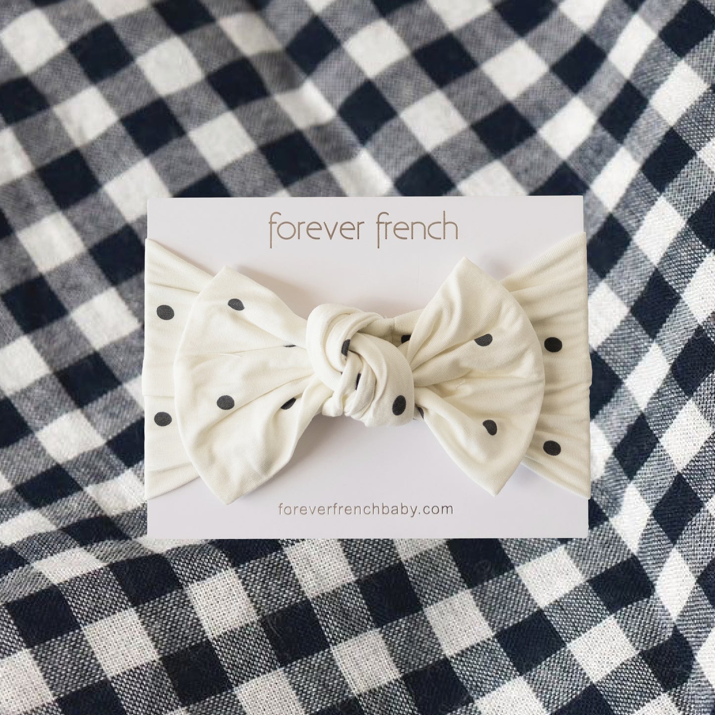 The Bamboo Head Wrap | Annie from forever french baby is shown on a branded card, set against a black-and-white checkered fabric background.