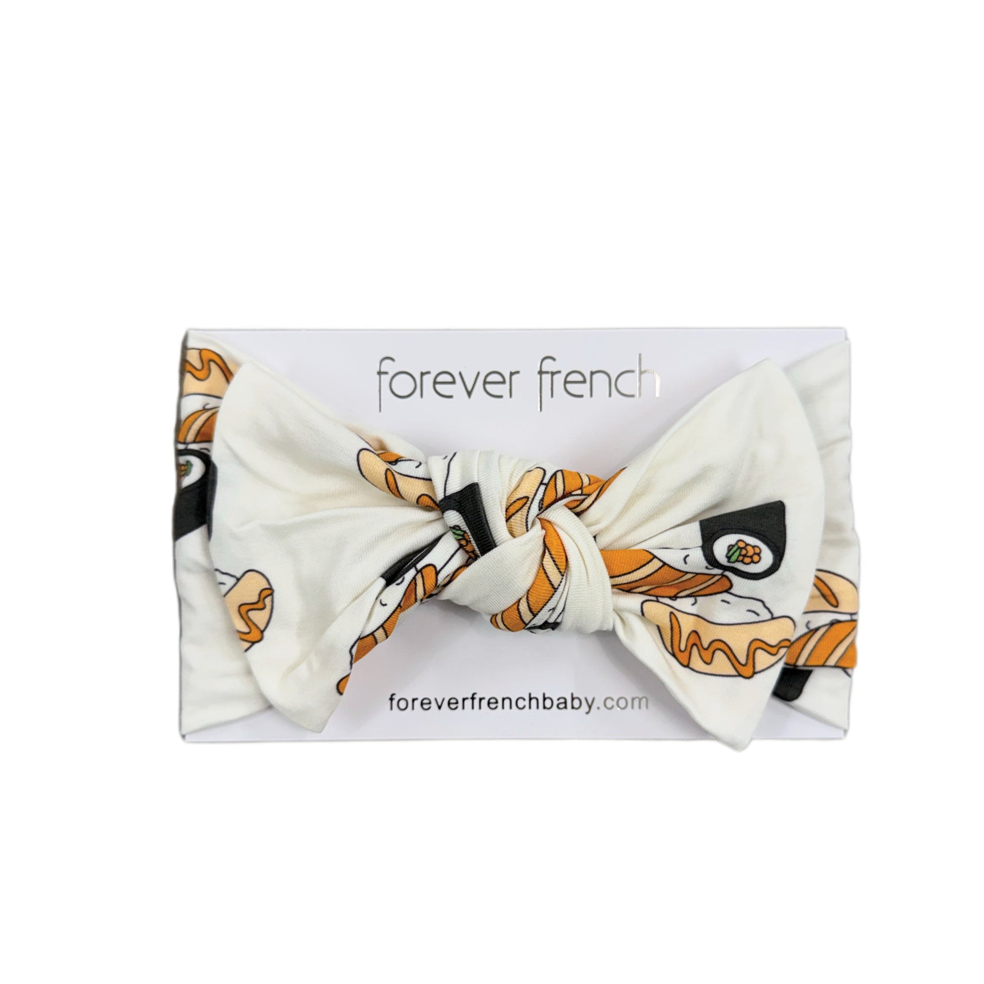 A bamboo head wrap in a sushi print, displayed on a "forever french baby" branded card—perfect for adding a playful touch to your little one's style.