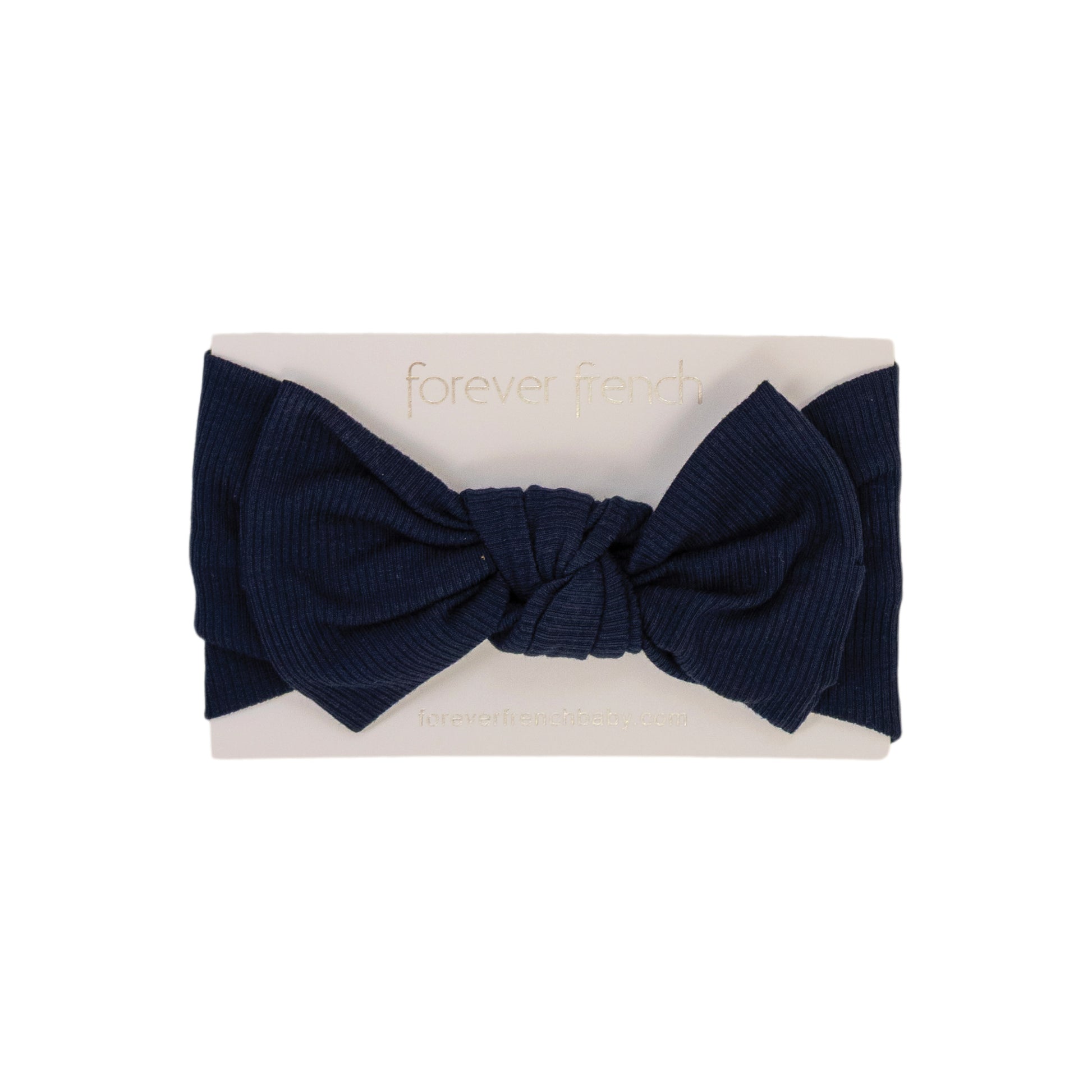 The Bamboo Head Wrap | Blueberry Ribbed from forever french baby is a navy ribbed bow headband, shown on a white card with gold "forever french" text.