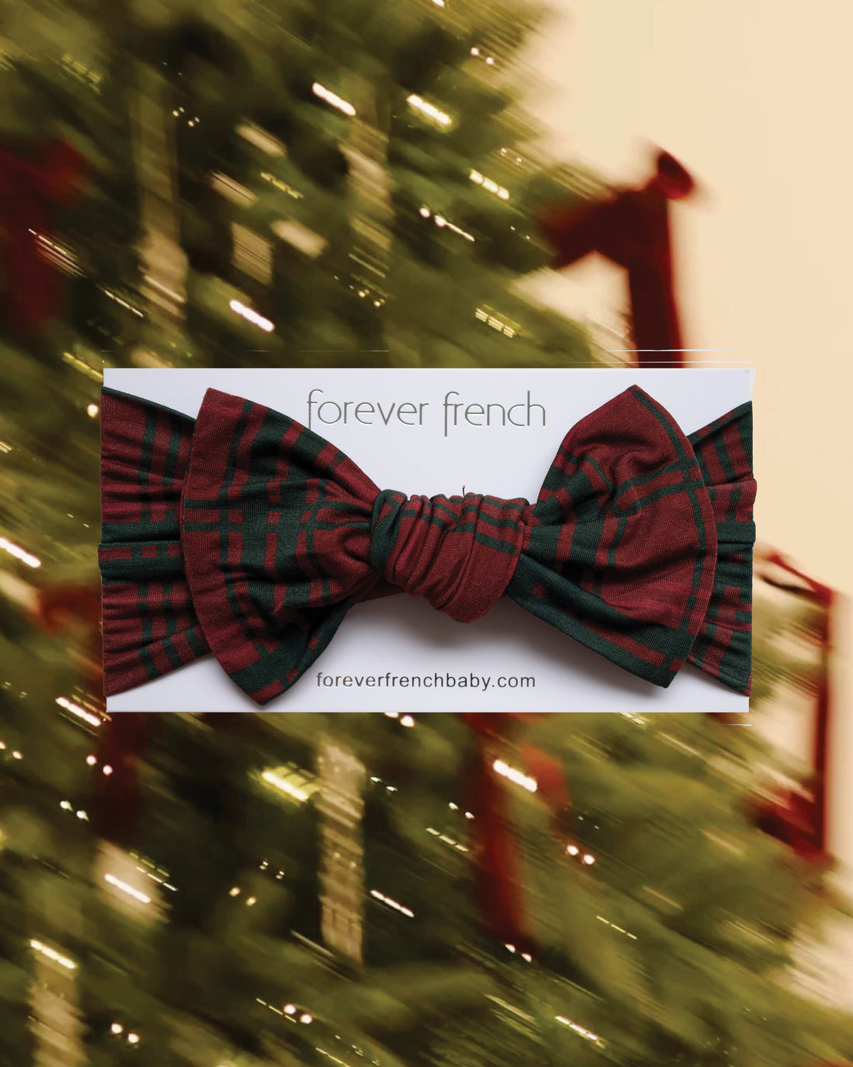 A red and dark green Bamboo Head Wrap | Christmas Plaid with a large center bow, displayed on a product card.