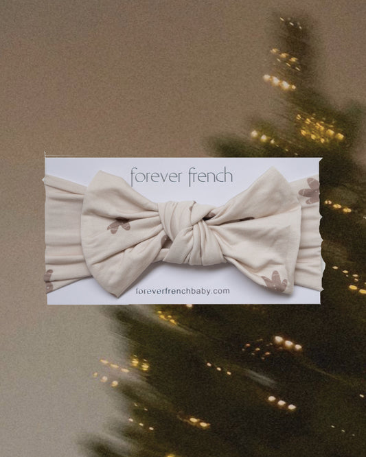 Gingersnap Bamboo Head Wrap in cream with a knotted bow and brown floral print, displayed on a forever french baby branded card.