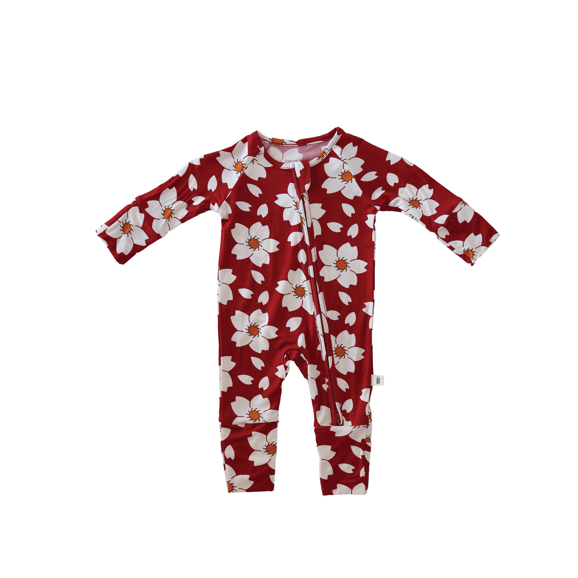 The Bamboo Zip Pajamas | Cherry Blossoms by forever french baby are red, long-sleeve onesies with a white floral pattern and diagonal zipper, made from hypo-allergenic fabric. Shown on a white background.