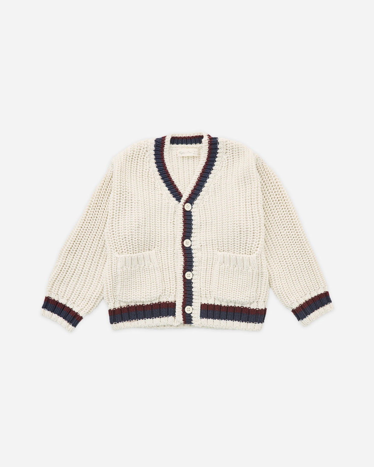 The Rylee + Cru Collegiate Cardigan in Natural is a cream-colored V-neck sweater featuring navy and burgundy trim on the collar, cuffs, and hem. Accented with unique mango wood buttons and finished with two front pockets for a refined collegiate style, the cardigan is displayed laid flat against a white background.