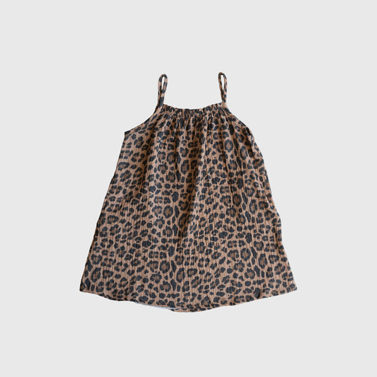 The forever french baby Child Muslin Sleeveless Dress | Leopard features a sleeveless, knee-length design with spaghetti straps and a brown and black leopard print, shown on a plain white background.