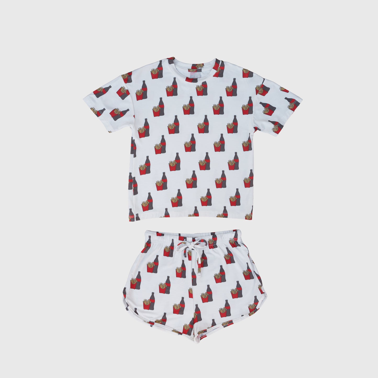 The Girl's Bamboo Short Set | Fries & Cola by forever french baby features a white short-sleeve shirt and shorts with red and yellow French fry cartons, made from hypo-allergenic, breathable bamboo for all-night comfort.
